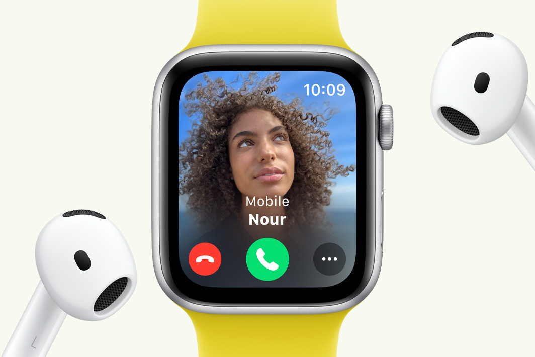 Apple Watch SE showing an incoming call, next to a pair of AirPods