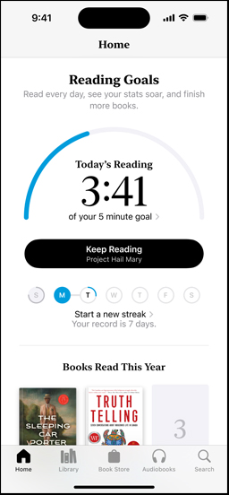 iPhone screen showing the Reading Goals interface in the Books app. At the top, there is a progress ring. Below the progress ring is the weekly reading streak tracker. At the bottom is the Books Read This Year section, which includes a row of two books, with an empty slot for a third