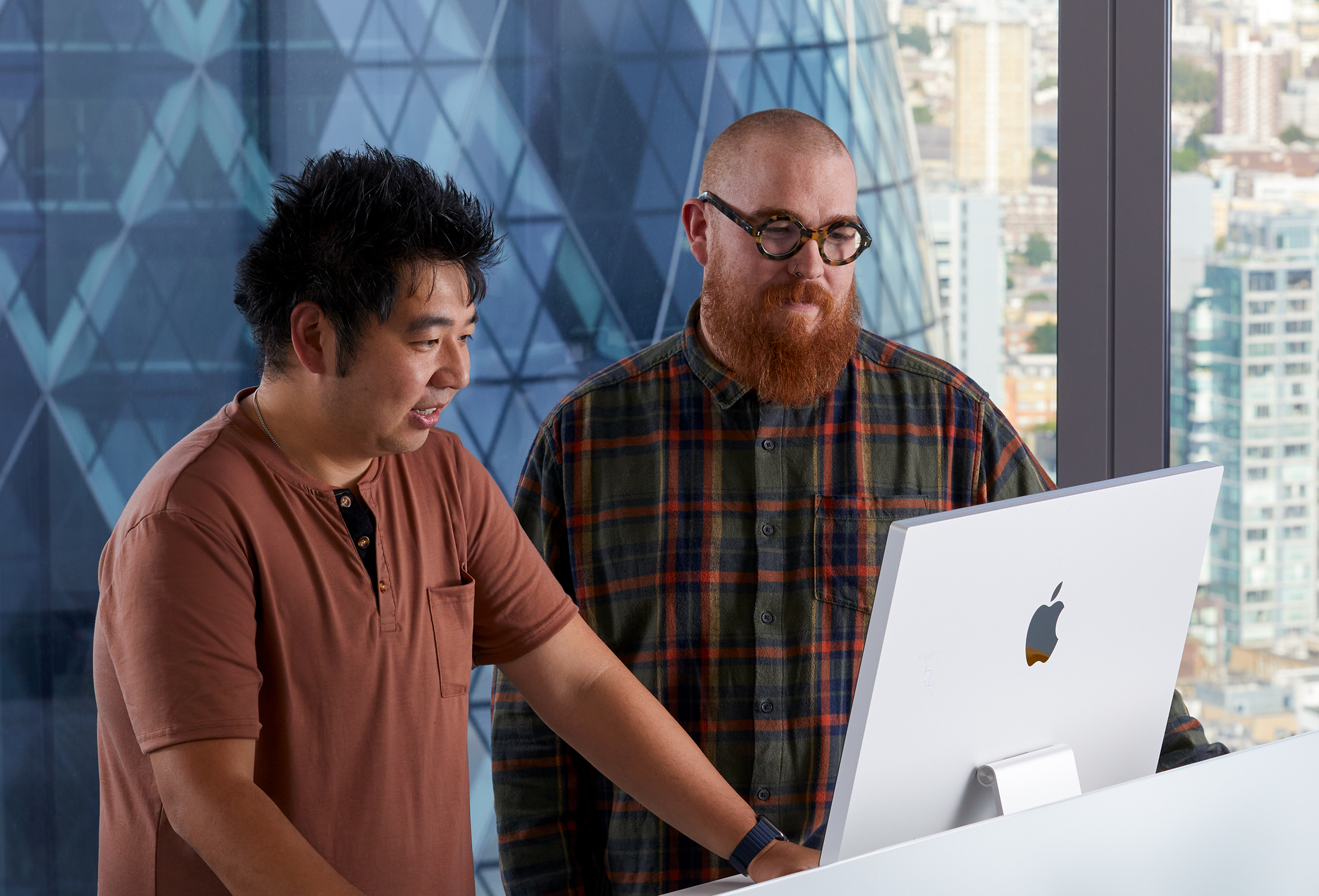 Due dipendenti Apple che lavorano insieme usando un iMac.