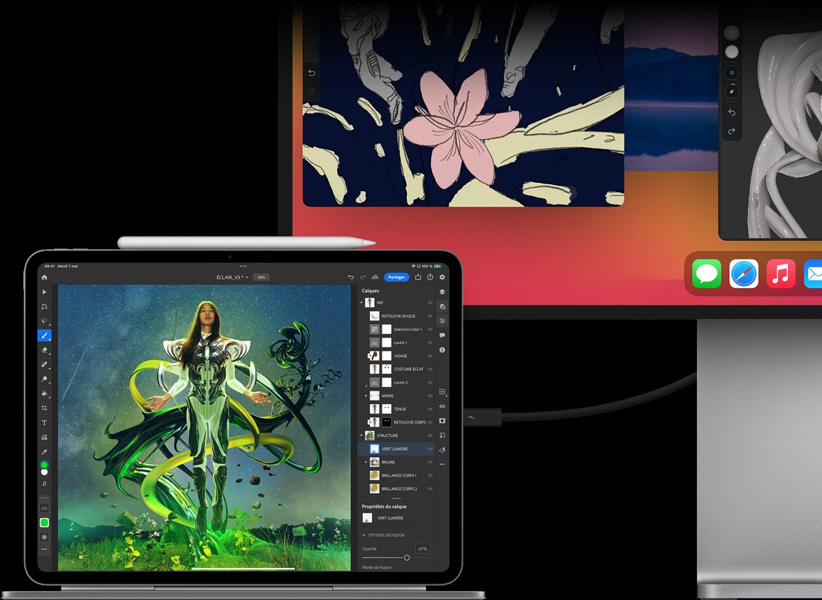 iPad Pro fixé à un Magic Keyboard en mode paysage, connecté à un écran externe, des images en cours de modification sur les deux écrans