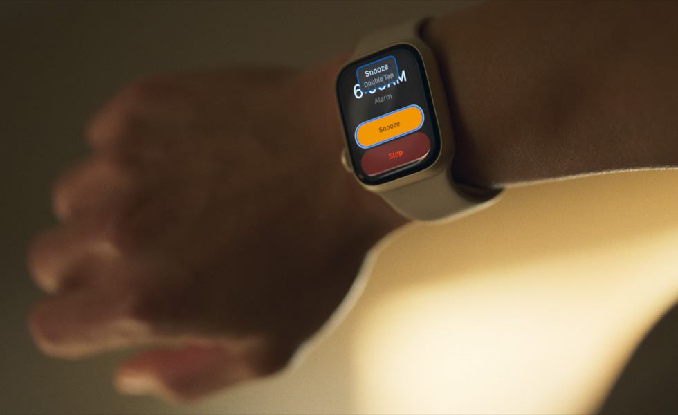 An arm with an Apple Watch. It says "Snooze, double tap" on the screen.