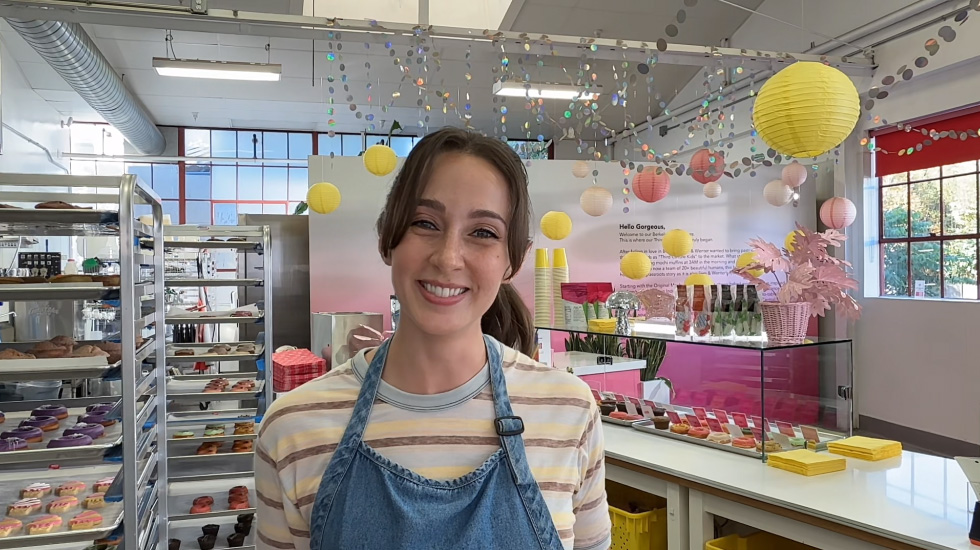 Woman on a video call working at a bakery.